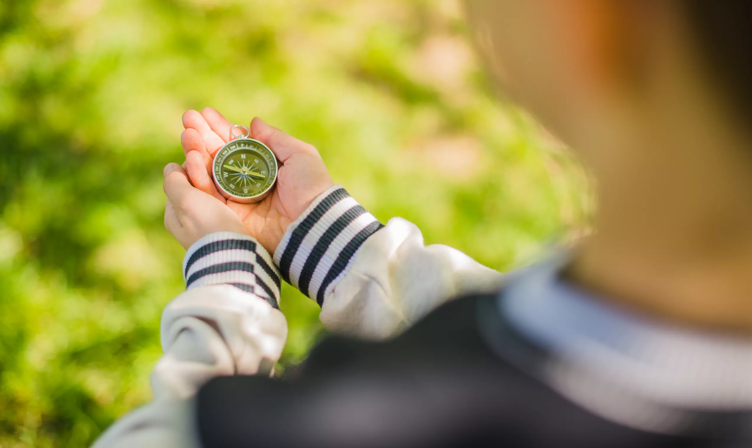 boy-holding-compass-park -  - Homepage